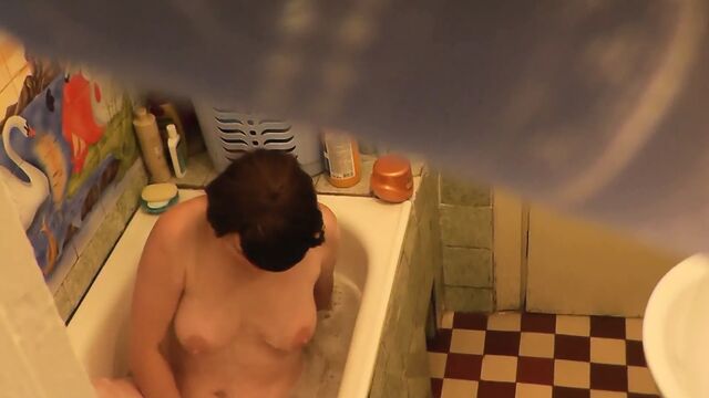 The foster mother takes a bath, masturbates her pussy to a strong orgasm, a student foster son who came from college spies on her