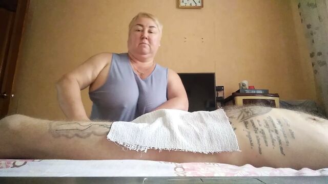 She massages my legs and jerks my dick