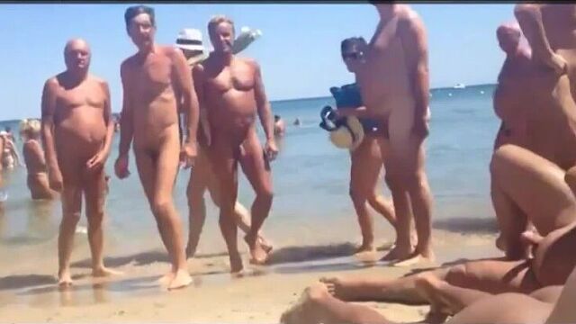 on the beach with nudists, a line lined up, filming on the phone. Russian porn,