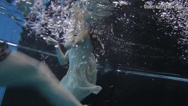Two young girls in the pool, first in dresses and then naked. Erotica underwater